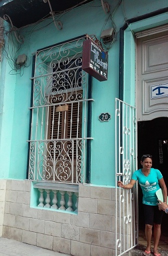 'Host and house front' Casas particulares are an alternative to hotels in Cuba.